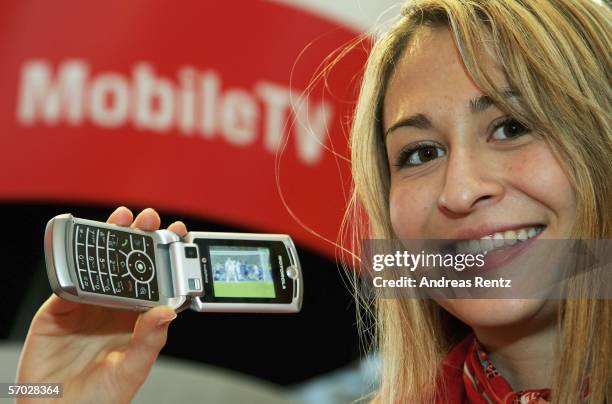 Model presents a 3G handy displaying it's mobile television channel feature at the CeBIT computer fair in the northern German town on March 8, 2006...