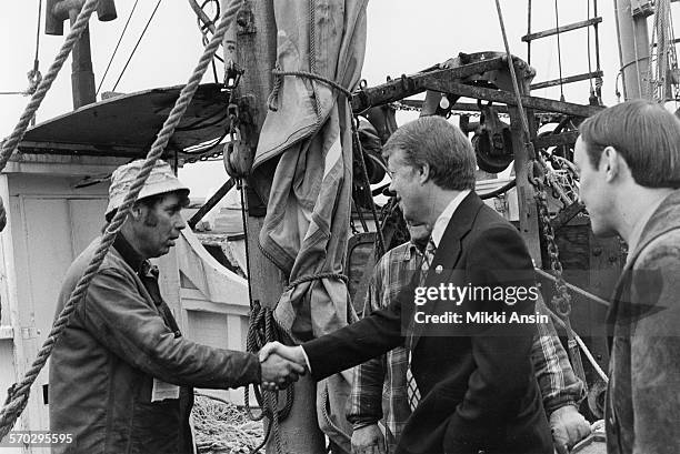 American politician and Presidential candidate Jimmy Carter speaks with fishermen about fishing rights in New Bedford, Massachusetts, 1976.