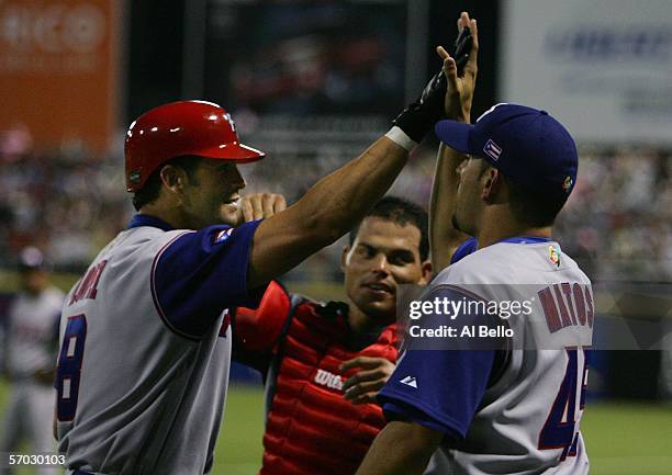 Javy Lopez of Puerto Rico celebrates with Josue Matos after hitting a home run off of Dirk Van 't Klooster of The Netherlands during their game at...