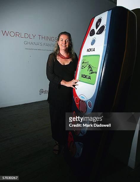 Lisa Warrener, Cultural Producer at Exhibitions for Festival Melbourne 2006, studies a Fantasy Coffin in the shape of a mobile phone at 45 Downstairs...