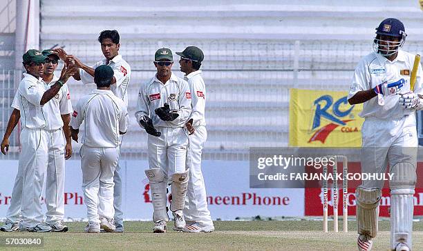 Bangladeshi pacer Shahadat Hossain celebrates with his teammates the dismissal of Sri Lankan batsman Thilan Samaraweera during the second day of the...