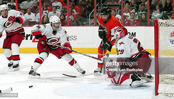 Peter Forsberg of the Philadelphia Flyers trys to deflect a shot past Martin Gerger of the Carolina Hurricanes at the Wachovia Center on March 8,...