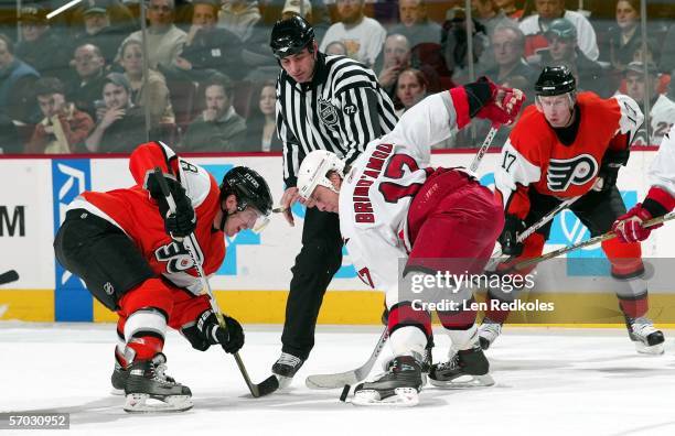 Mike Richards of the Philadelphia Flyers faces-off against Rod Brind'Amour of the Carolina Hurricanes at the Wachovia Center on March 8, 2006 in...