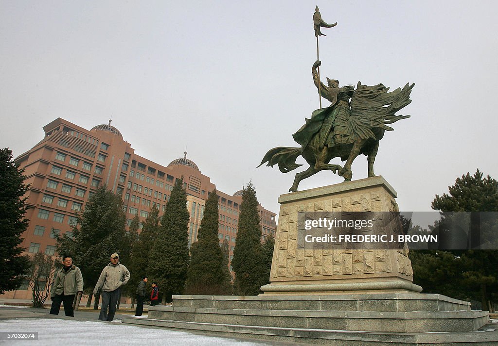 Students approach a statue of Mongolian