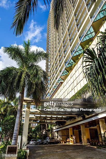 Palm trees and front exterior entrance of Trump International Hotel Waikiki Beach. Five Star luxury hotel & residences owned by Donald Trump, wealthy...