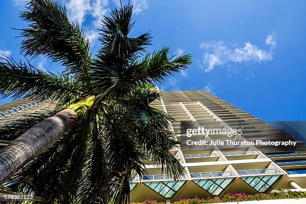 Palm tree and exterior of Trump International Hotel Waikiki Beach. Five Star luxury hotel & residences owned by Donald Trump, wealthy outspoken...