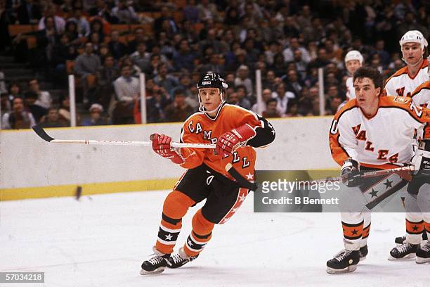 Steve Yzerman of the Campbell Conference and the Detroit Red Wings eyes the puck as he is pursued by Mike O'Connell and Ray Bourque of the Wales...