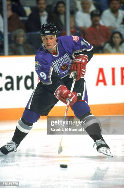 Canadian professional hockey player Steve Yzerman, center for the Detroit Red Wings, plays with the puck on the ice during the NHL All Star Game, San...