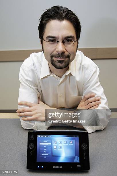 In this handout image provided by Microsoft, Otto Berkes, general manager of Microsoft's Ultra-Mobile Personal Computer Division, poses with the...