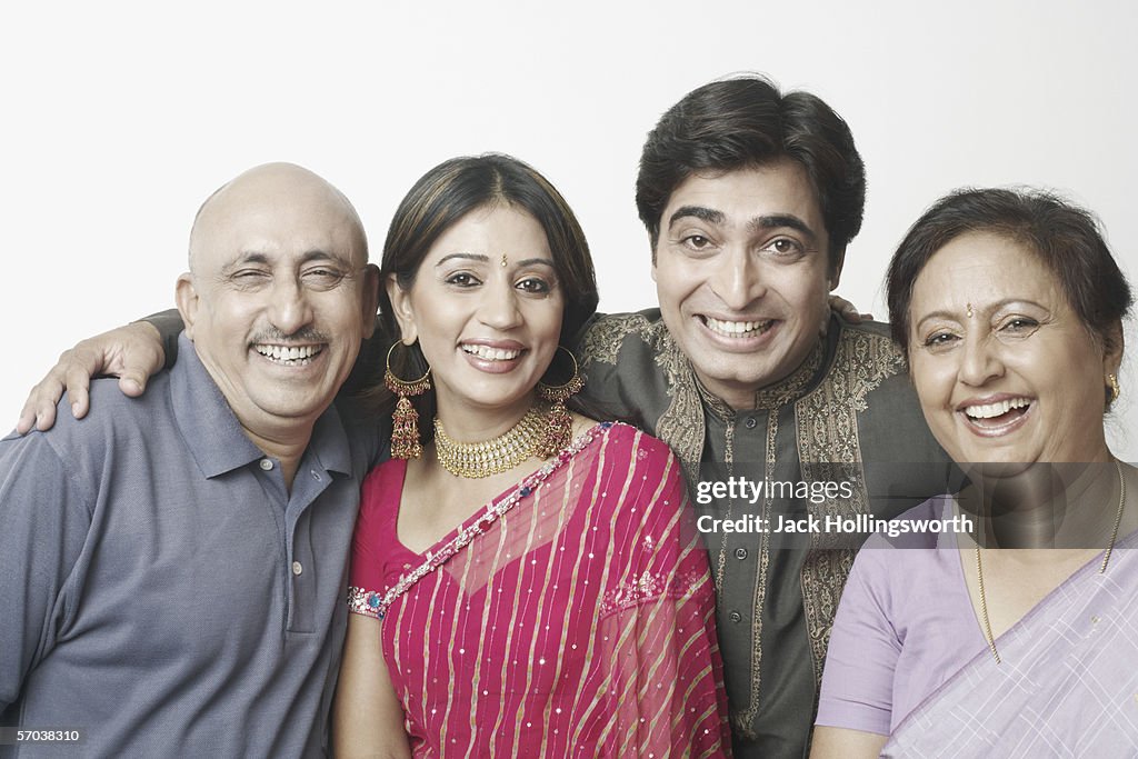 Portrait of a mature couple and a mid adult couple smiling