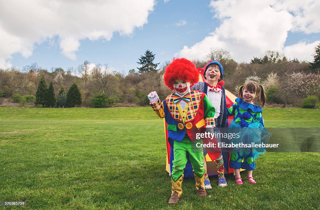 Three children dressed as clowns