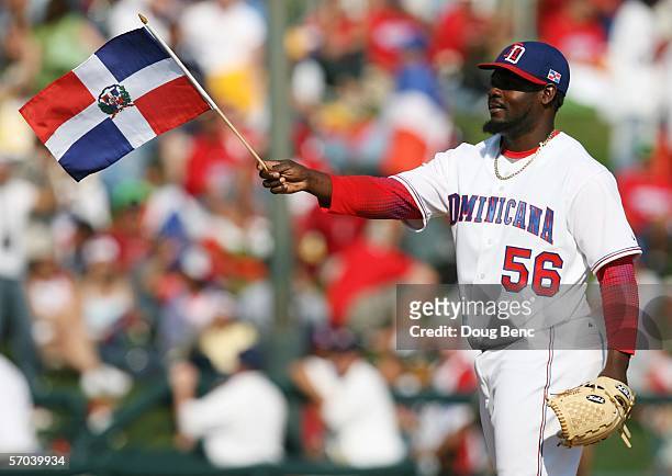 Relief pitcher Fernando Rodney of the Dominican Republic waves a flag as he enters the game in the beginning of the ninth inning against Italy in a...