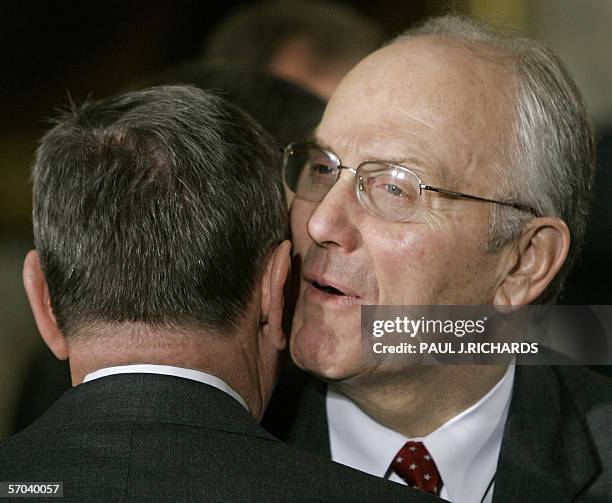 Washington, UNITED STATES: US Senator Larry E. Craig whispers to former US Attorney General John Ashcroft after US President George W. Bush signed...