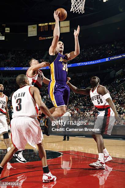 Chris Mihm of the Los Angeles Lakers takes the ball to the basket against Viktor Khryapa, Juan Dixon and Zach Randolph of the Portland Trail Blazers...