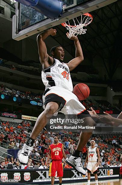 Kenny Cooper of the Oklahoma State Cowboys goes up for a slam dunk against the Iowa State Cyclones during the first round of the Phillips 66 Big 12...