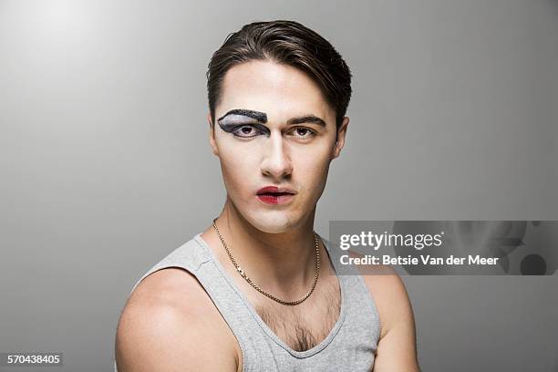 cross dresser with half of face made up. - halved stockfoto's en -beelden