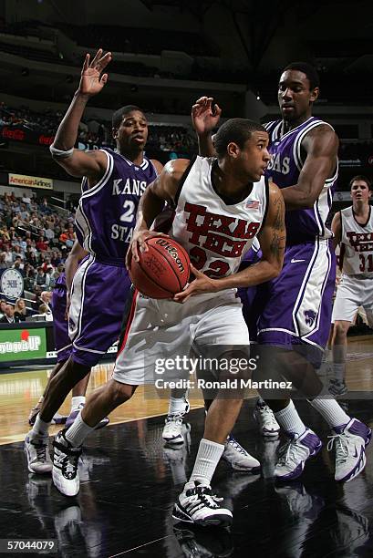 Jarrius Jackson of the Texas Tech Red Raiders dribbles the ball under the basket against the Kansas State Wildcats in the first round of the Phillips...