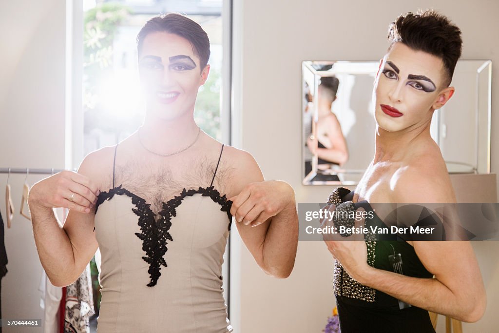 Cross dressers checking their clothes in mirror
