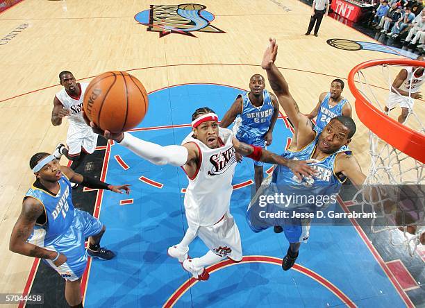 Allen Iverson of the Philadelphia 76ers goes up for a shot against Marcus Camby of the Denver Nuggets on March 9, 2006 at the Wachovia Center in...