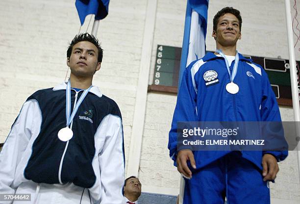 Tegucigalpa, HONDURAS: Rudy Rodas of Guatemala, in the 55-kg judo category poses with his silver medal with Kenny Godoy of Honduras in the same...