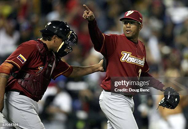 Closing pitcher Francisco Rodriguez of Venezuela points toward fans as catcher Henry Blanco congratulates him after a strikeout to end the game...