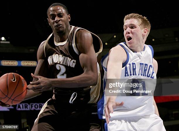 Justin Williams of the Wyoming Cowboys grabs a rebound from Jacob Burtschi of the Air Force Academy Falcons as the Cowboys upset the Falcons 57-55...