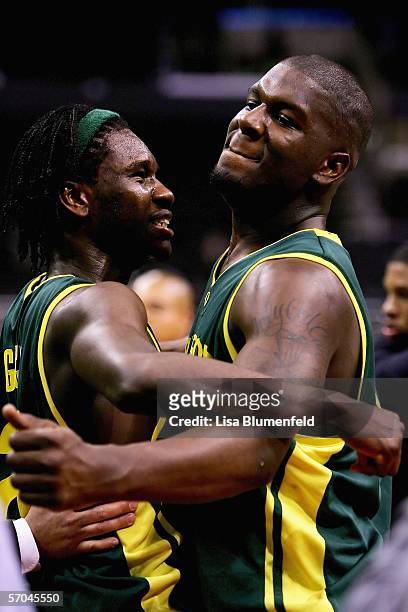 Chamberlain Oguchi and Ivan Johnson of the Oregon Ducks celebrate after upseting the Washington Huskies during the quarterfinals of the 2006 Pacific...