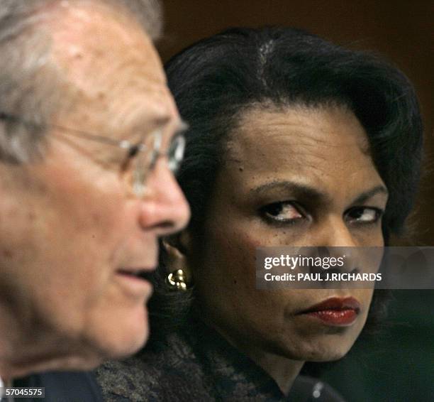 Washington, UNITED STATES: US Secretary of State Condoleezza Rice listens as US Secretary of Defense Donald Rumsfeld testifies during a Senate...