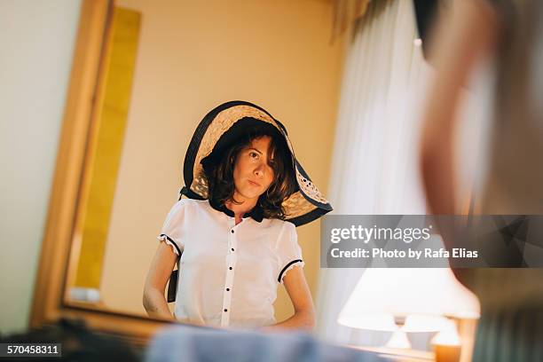 elegant woman in front of mirror - uncool fotografías e imágenes de stock