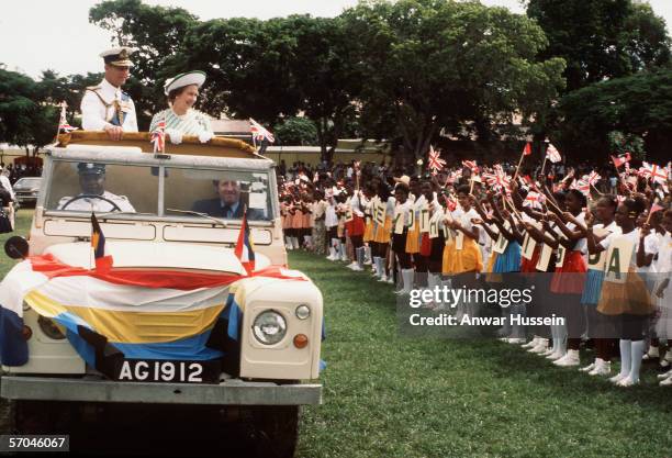 Queen Elizabeth ll and Prince Phillip, Duke of Edinburgh drive among the crowds during the Royal Tour in the Bahamas in 1977.