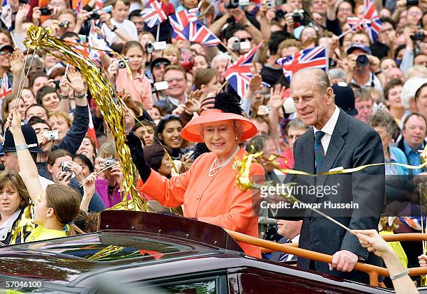 Queen Elizabeth II and Prince Phillip the Duke of Edinburgh ride along the Mall in an open top car on their way to watch a parade in celebration of...