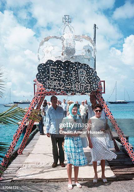 Queen Elizabeth II arrives in Mustique, Saint Vincent and is welcomed by Princess Margaret in 1977.