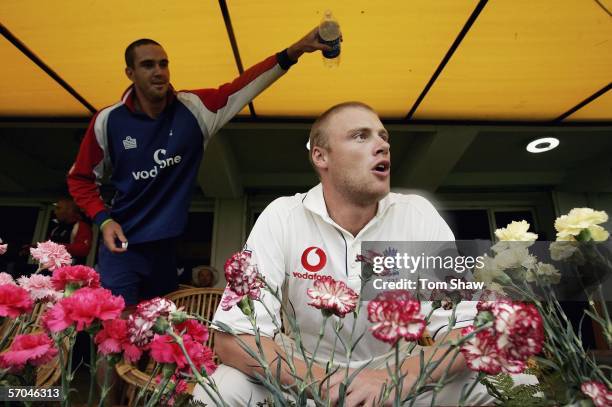 England captain Andrew Flintoff looks out from the dressing room as Kevin Pietersen of England pours water on his back during day two of the Second...