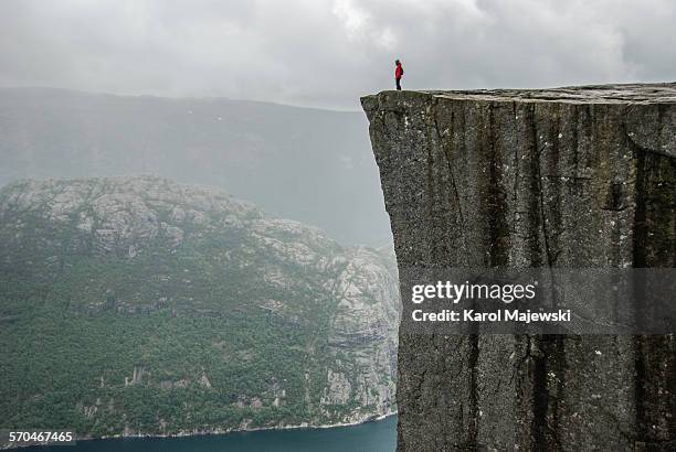 at the edge of a cliff - cliff edge stock pictures, royalty-free photos & images