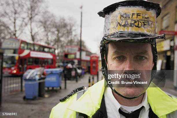 Artist Mark McGowan, dressed in a mock parking attendant uniform, poses for a photograph outside Bethnal Green Underground station on March 10, 2006...