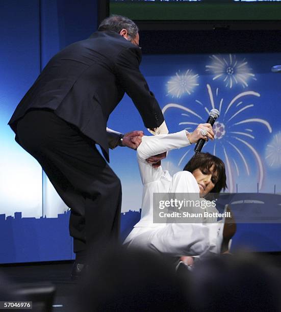 Television presenter Carole Rousseau faints during the UEFA Champions League Trophy Handover & Draw at The Hotel de Ville on March 10, 2006 in Paris,...