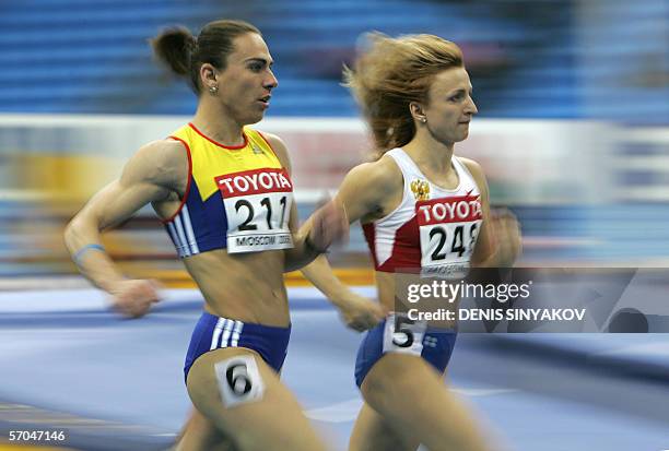 Moscow, RUSSIAN FEDERATION: Russia's Natalya Tsyganova and Romania's Maria Cioncan compete during the women's 800m heats at the 11th IAAF World...