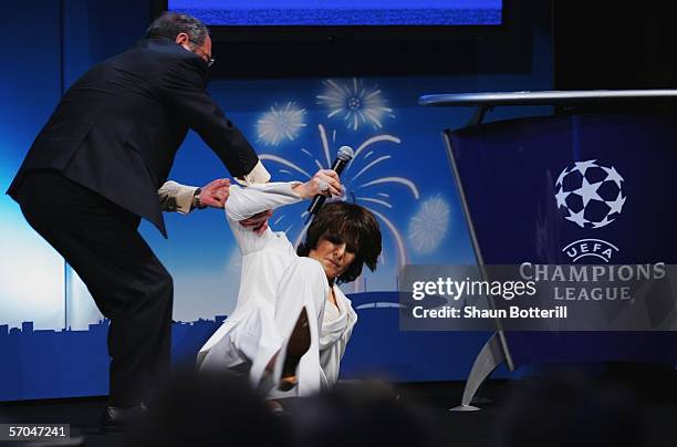 Television presenter Carole Rousseau faints during the UEFA Champions League Trophy handover and draw at The Hotel de Ville on March 10, 2006 in...