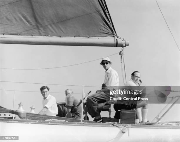 Prince Philip, Duke of Edinburgh seated on a horse-riding saddle at the helm of Uffa Fox's 20-ton yacht 'Fresh Breeze', while competing in the...