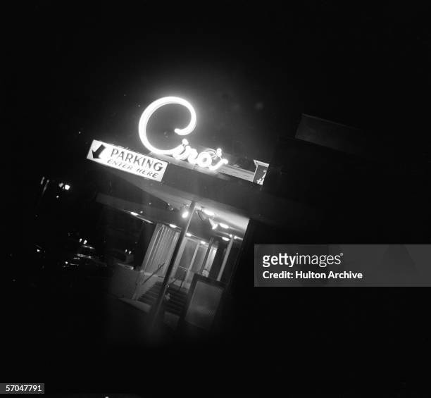 Slanted view at night of the lit up facade of Ciro's nightclub, located on Sunset Boulevard in West Hollywood, Los Angeles, California, mid 20th...
