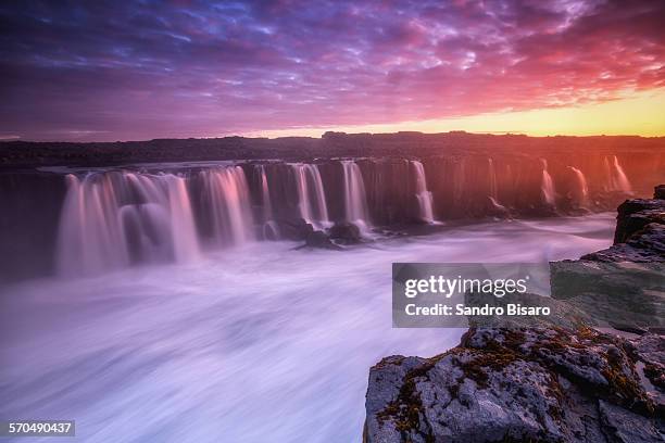 selfoss waterfall on a midnight sunset - フーサヴィーク ストックフォトと画像