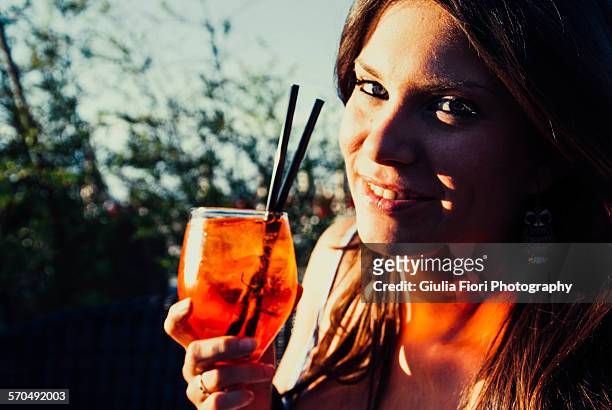 young woman holding a cocktail - brown hair blue eyes and dimples stock pictures, royalty-free photos & images