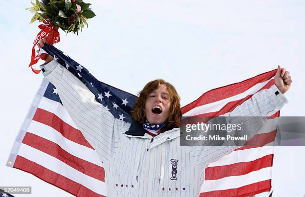 Shaun White of the USA celebrates winning the Gold medal in the Men's Halfpipe finals during Day 2 of the Turin 2006 Winter Olympic Games on February...