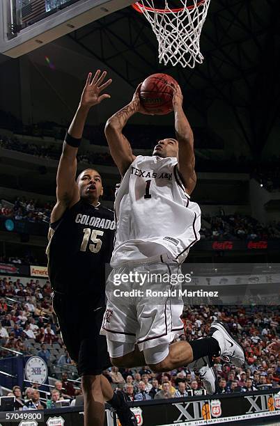 Acie Law of the Texas A&M Aggies goes up for a shot against Chris Copeland of the Colorado Buffaloes during the quarterfinals round of the Phillips...