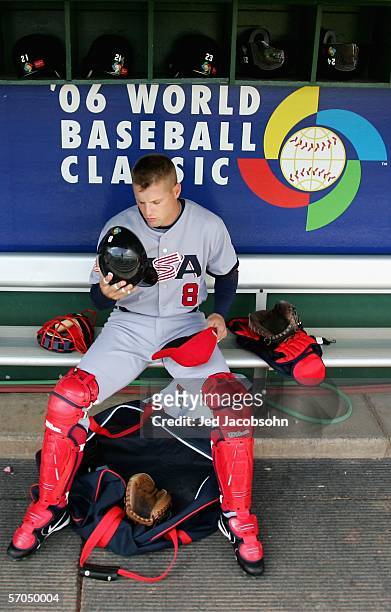 Catcher Michael Barrett of Team USA prepares his equipment before the start of the Round 1 Pool B Game of the World Baseball Classic against Team...
