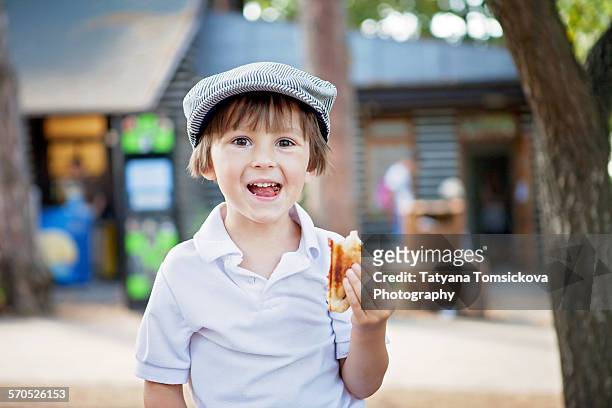 cute boy, child, eating sandwiches outdoor, summer - boy eating cereal stock pictures, royalty-free photos & images