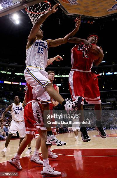 Mustafa Shakur of the Arizona Wildcats grabs a rebound away from Ryan Hollins of the UCLA Bruins during the semifinals of the 2006 Pacific Life...
