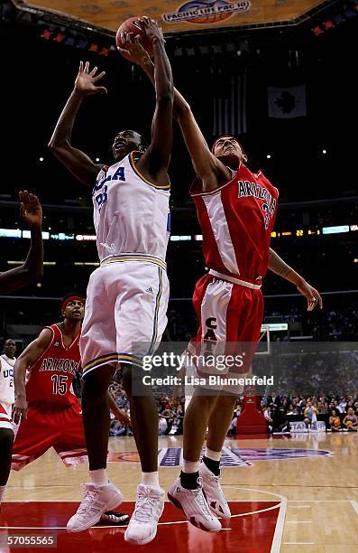 Luc Richard Mbah a Moute of the UCLA Bruins and Marcus Williams of the Arizona Wildcats reach for a rebound during the semifinals of the 2006 Pacific...