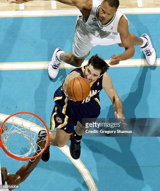 Paja Stojakovic of the Indiana Pacers gets a shot off around P.J. Brown of the New Orleans/Oklahoma City Hornets during a NBA game on March 10, 2006...