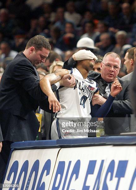 Allan Ray of the Villanova Wildcats is helped off the court after suffering an eye injury during the semifinals of the Big East Men's Basketball...